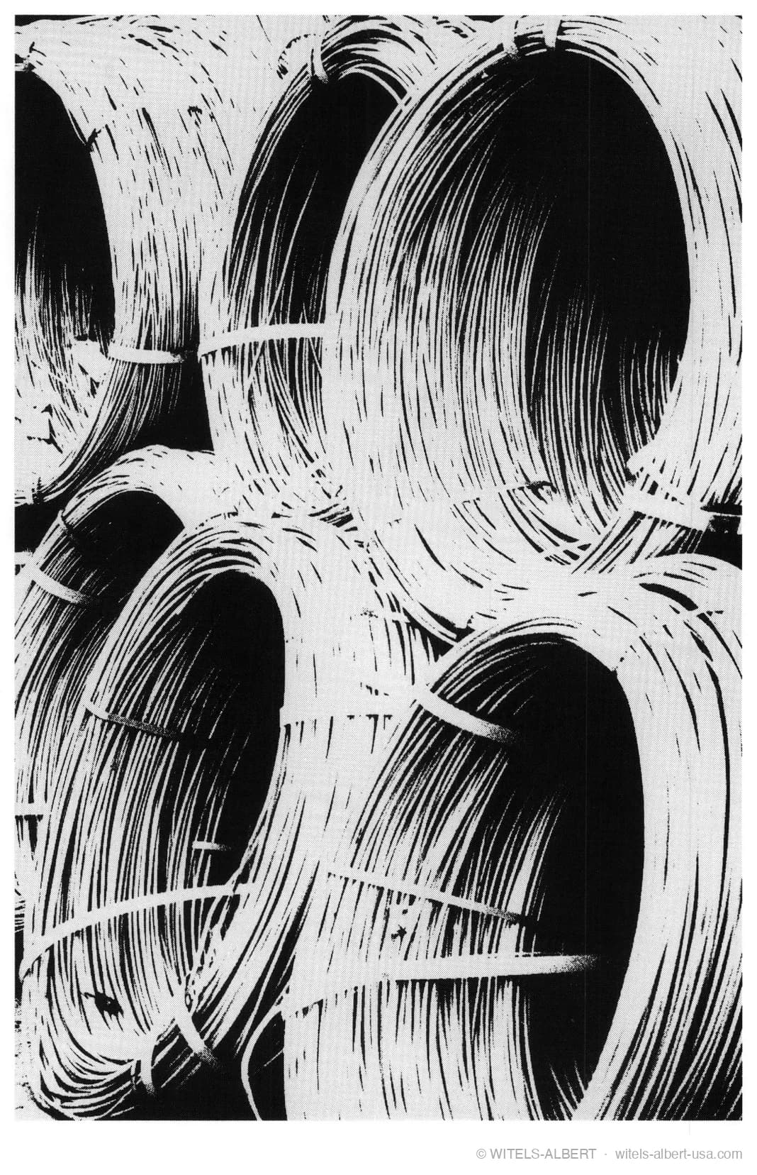 High-contrast photograph of large wire coils stacked together, each bundle bound with straps.