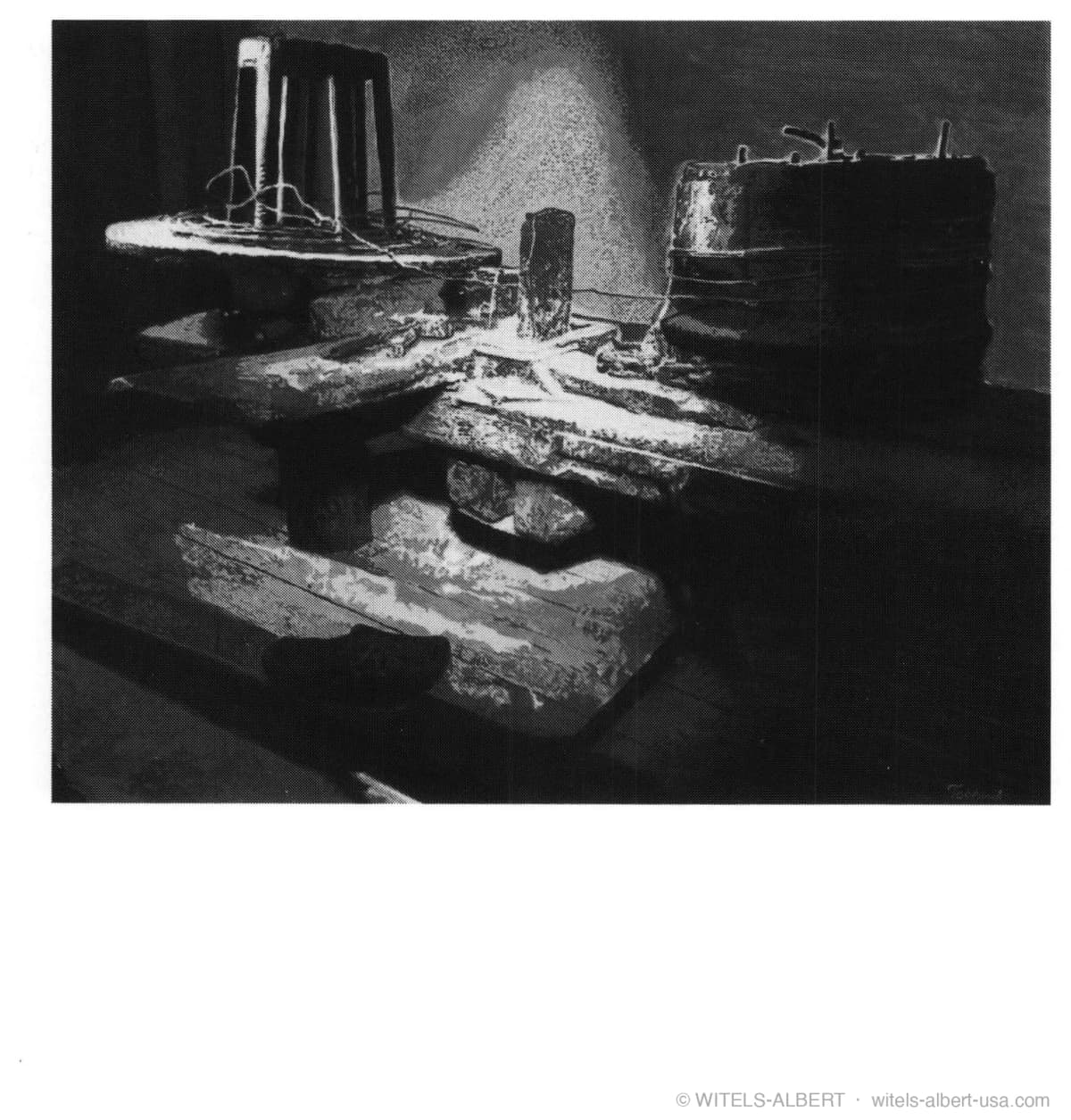 Photograph of a historical wooden model of an early wire-drawing workshop with a drawing bench and coiled wire.