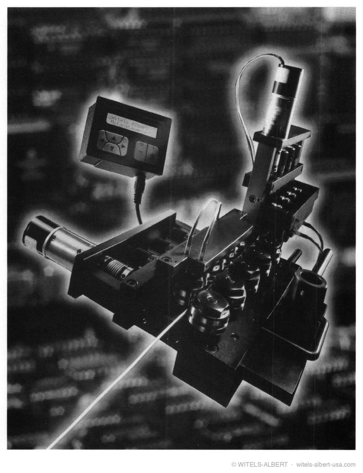 Photograph of a semi-automatic straightener with motorized roll adjustment and a handheld control unit with display and keypad, shown against a background of process data.